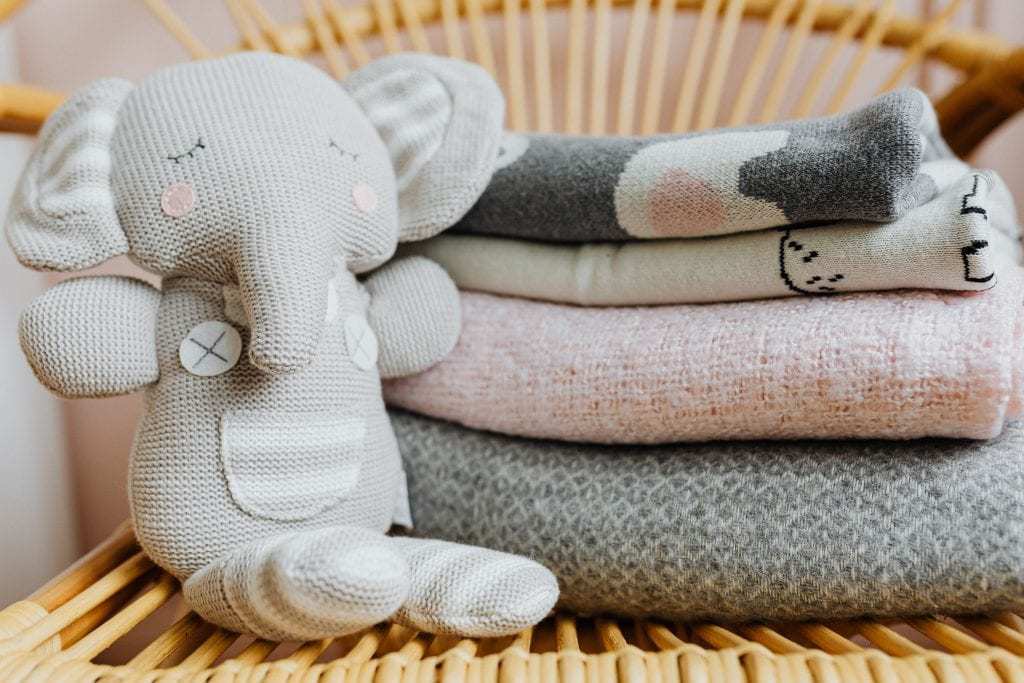 Stack of Baby Receiving Blankets with Baby Toy